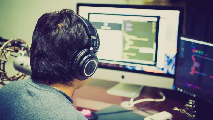 selective focus photography of man facing computer